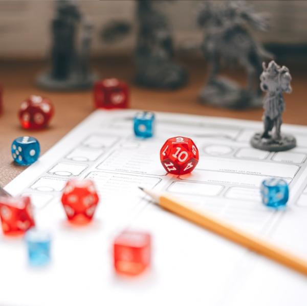 table top role playing game pieces - paper, pencil, multi-sided dice, miniatures